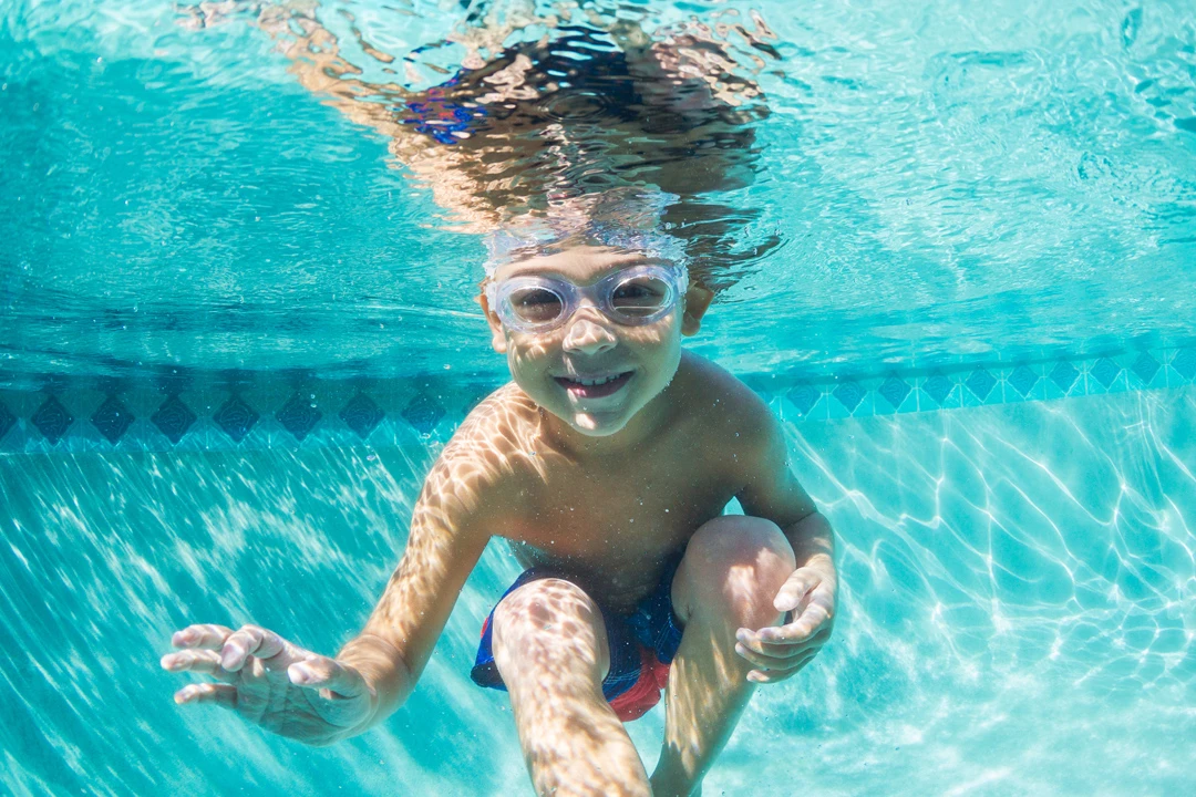 Child enjoying clear pool water