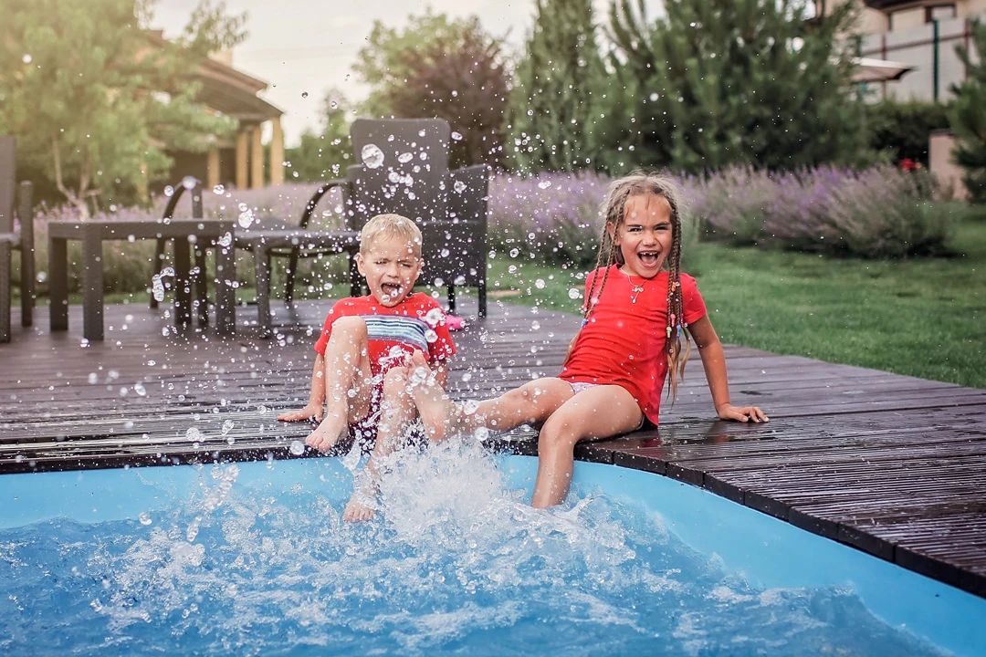 Children splashing at the pool edge